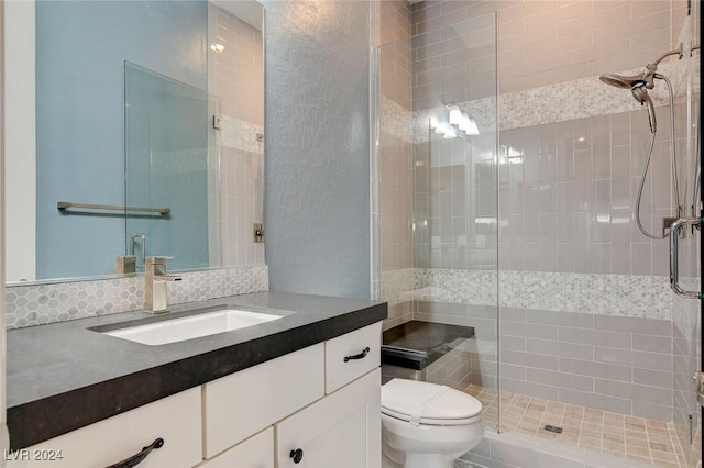 bathroom with vanity, toilet, and a shower with shower door