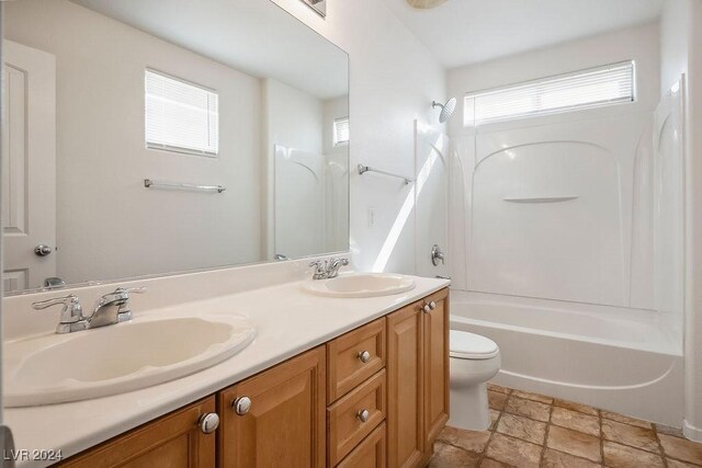 full bathroom featuring vanity, a wealth of natural light, shower / bathtub combination, and toilet