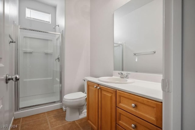 full bathroom featuring tile patterned floors, vanity, toilet, and a shower stall