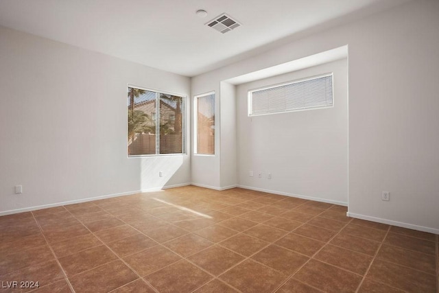 spare room with visible vents and baseboards