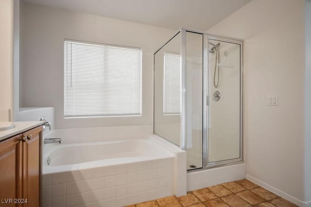 full bath featuring a garden tub, a healthy amount of sunlight, a stall shower, and vanity