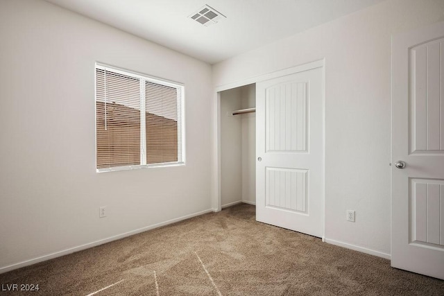 unfurnished bedroom featuring a closet, visible vents, carpet flooring, and baseboards