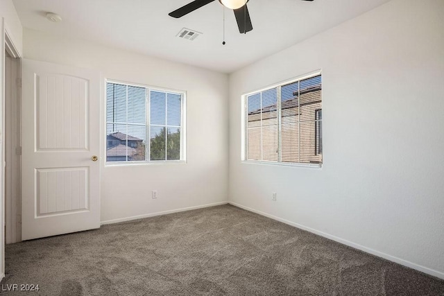 spare room featuring visible vents, baseboards, a ceiling fan, and carpet floors