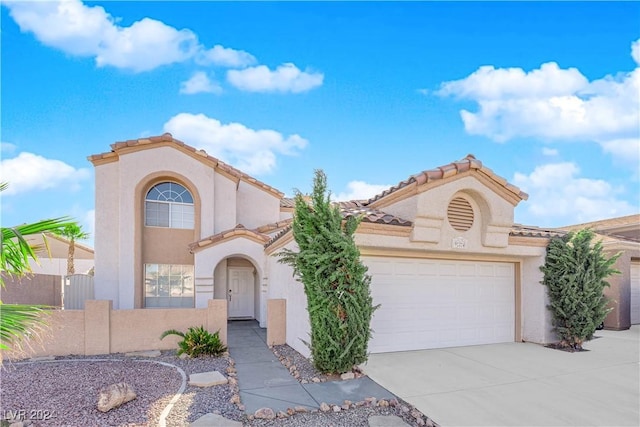 mediterranean / spanish-style home with a garage