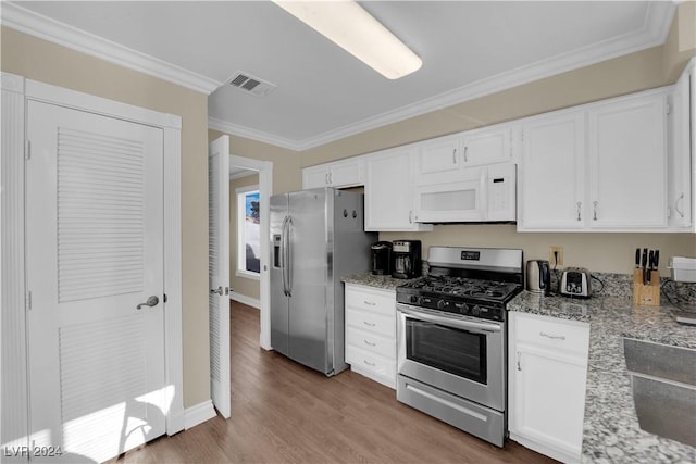 kitchen with crown molding, light hardwood / wood-style flooring, light stone counters, white cabinetry, and stainless steel appliances