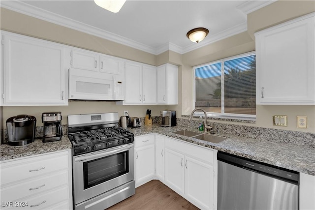 kitchen featuring white cabinetry, sink, and appliances with stainless steel finishes