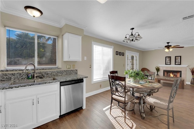 kitchen featuring stainless steel dishwasher, sink, stone counters, dark hardwood / wood-style floors, and white cabinetry