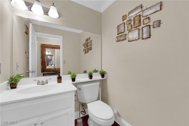 bathroom with vanity, toilet, and ornamental molding