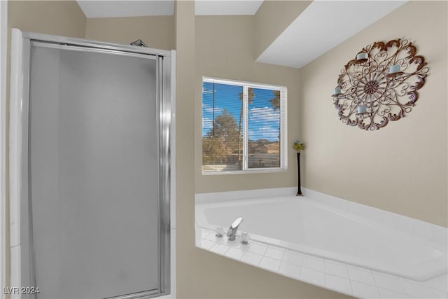 bathroom featuring shower with separate bathtub