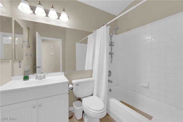 full bathroom with shower / bath combo, vanity, and toilet