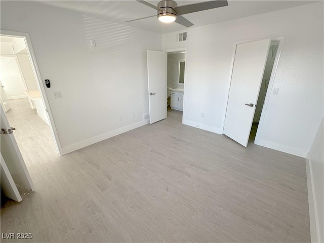 unfurnished bedroom with light wood-style floors, baseboards, and visible vents