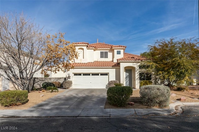 mediterranean / spanish-style home with a garage