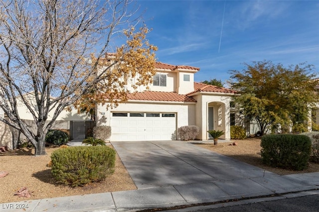 mediterranean / spanish-style home with a garage