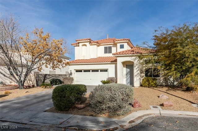 mediterranean / spanish house featuring a garage