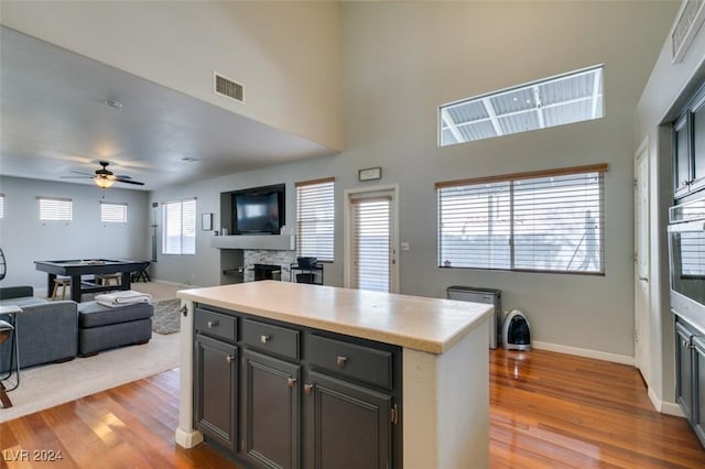 kitchen featuring ceiling fan, a kitchen island, light hardwood / wood-style floors, and billiards