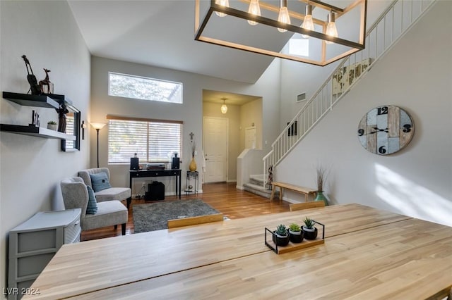 living room with a high ceiling and hardwood / wood-style floors