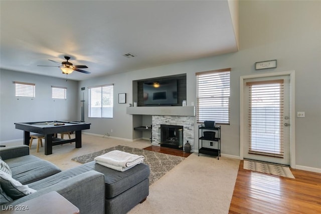 living room with hardwood / wood-style floors, ceiling fan, a healthy amount of sunlight, and a fireplace