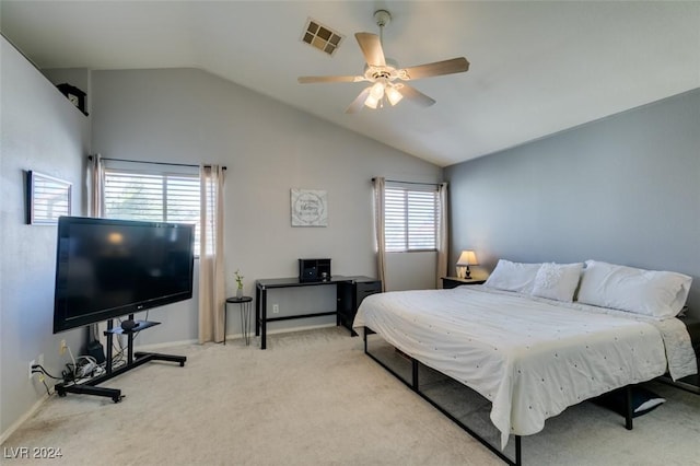 carpeted bedroom featuring multiple windows, ceiling fan, and vaulted ceiling