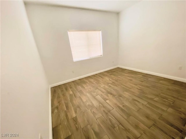 empty room with hardwood / wood-style flooring