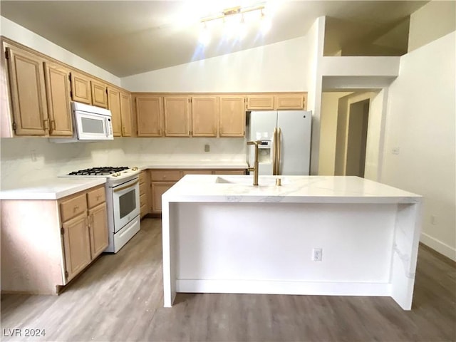 kitchen with a center island with sink, white appliances, sink, and light hardwood / wood-style flooring