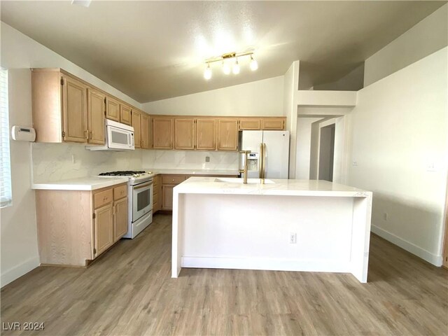 kitchen with tasteful backsplash, light hardwood / wood-style floors, lofted ceiling, white appliances, and a kitchen island with sink