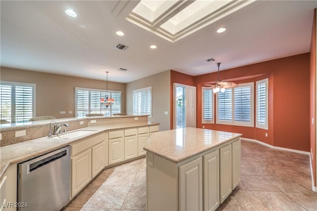 kitchen with sink, a kitchen island, pendant lighting, and stainless steel dishwasher