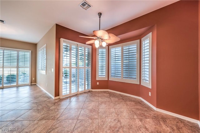 unfurnished dining area featuring ceiling fan and light tile patterned floors