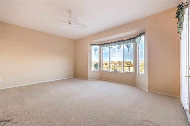 carpeted empty room featuring ceiling fan