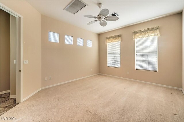 carpeted empty room with ceiling fan