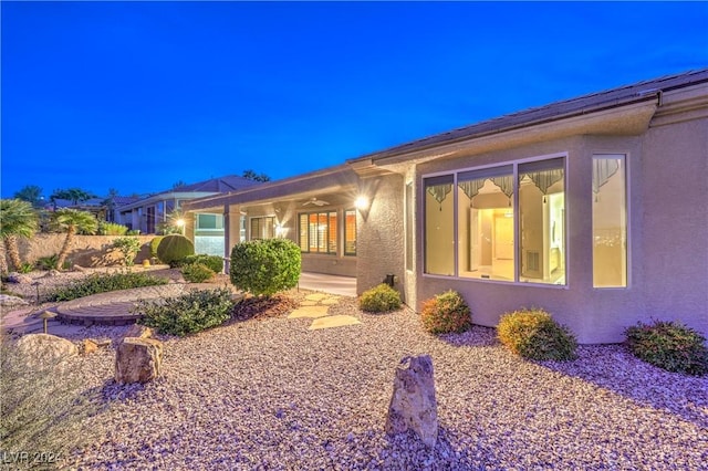 exterior space featuring ceiling fan