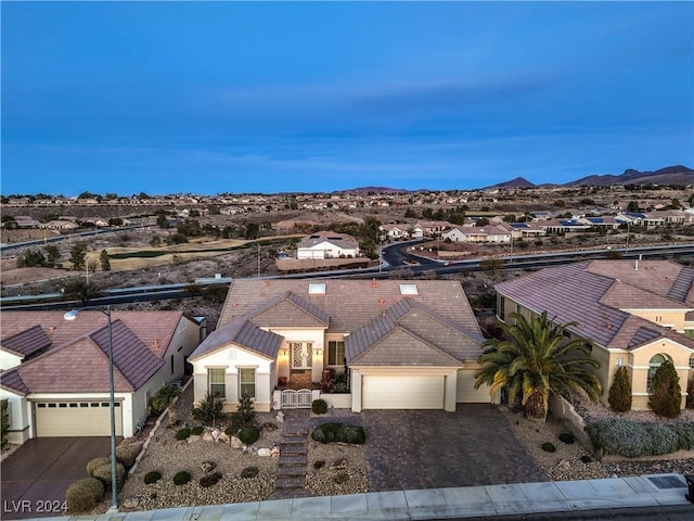 view of front of home with a mountain view and a garage