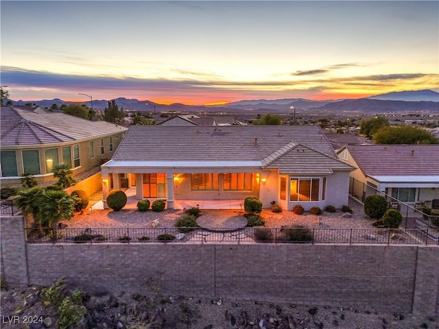 back house at dusk featuring a mountain view