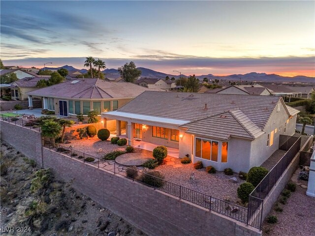 back house at dusk featuring a mountain view