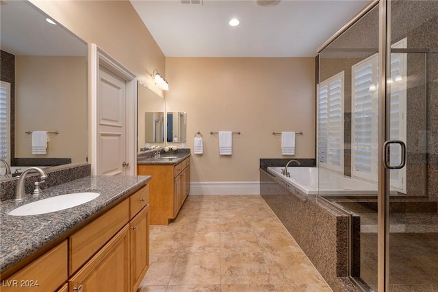 bathroom with vanity and separate shower and tub