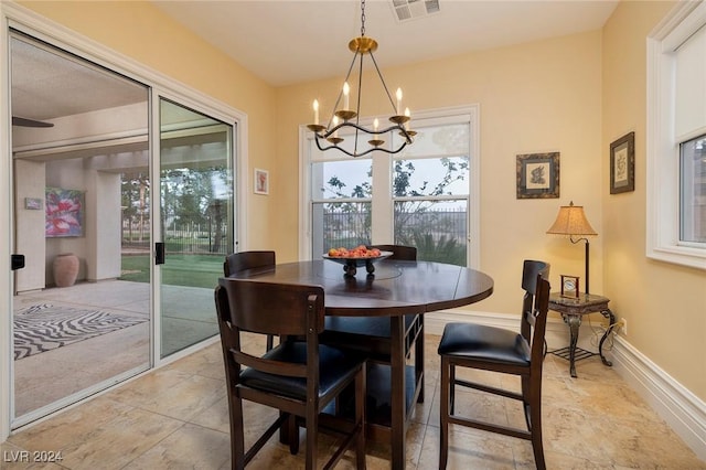 dining room with light tile patterned flooring and a chandelier