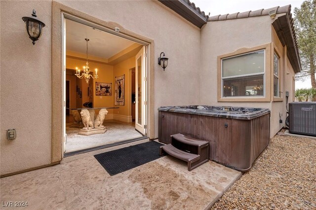 view of patio with a hot tub and central AC unit