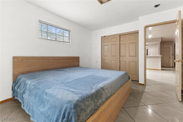 tiled bedroom featuring a closet