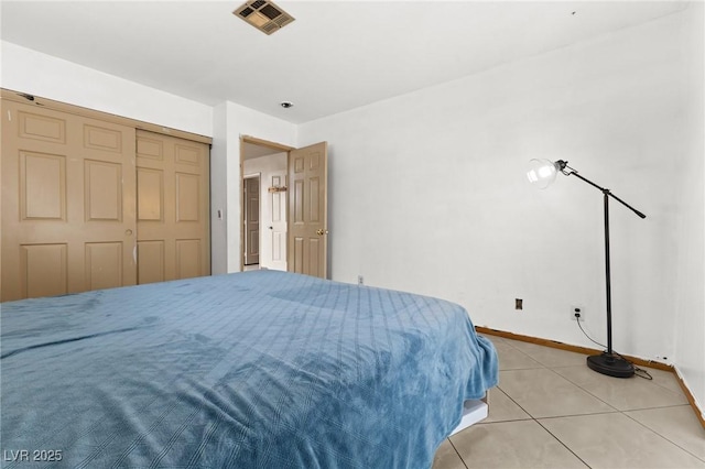 bedroom featuring a closet and light tile patterned flooring