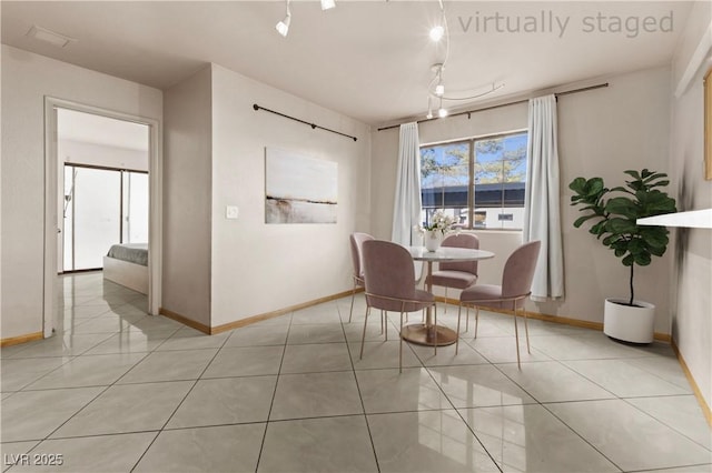 tiled dining room with track lighting