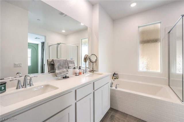 bathroom featuring vanity, a healthy amount of sunlight, and shower with separate bathtub