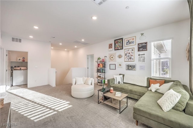 carpeted living room featuring washer / clothes dryer