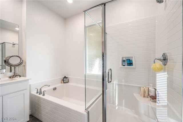 bathroom featuring vanity and separate shower and tub