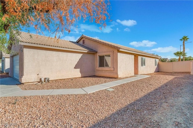 back of house featuring a garage