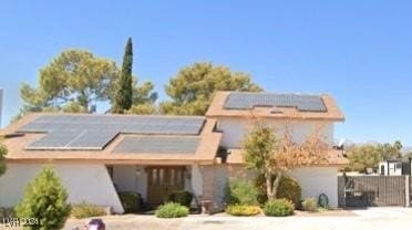 view of front facade featuring solar panels