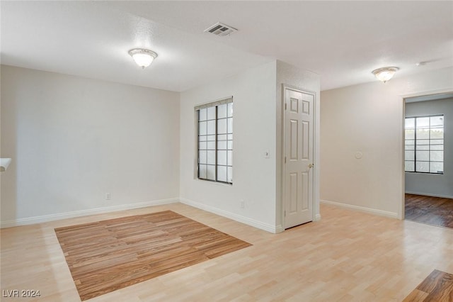 unfurnished room with light hardwood / wood-style floors