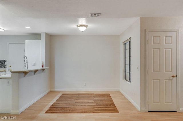 unfurnished dining area featuring light hardwood / wood-style flooring