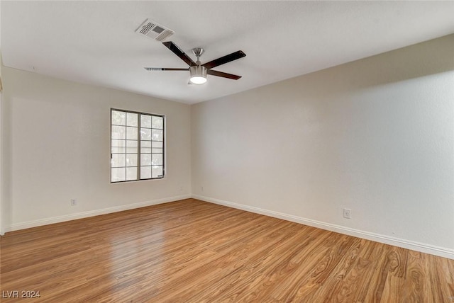 empty room with ceiling fan and light wood-type flooring