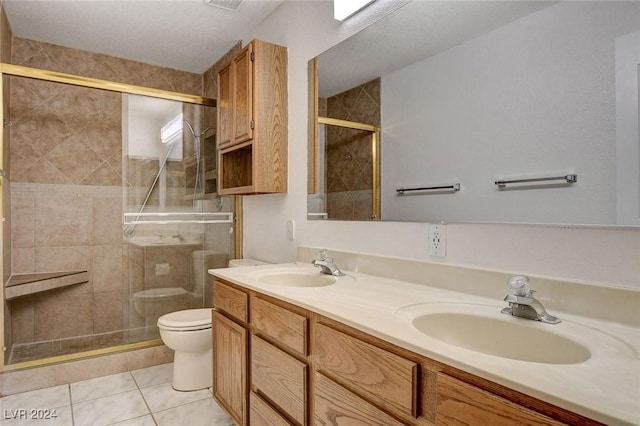 bathroom with vanity, an enclosed shower, tile patterned floors, and toilet