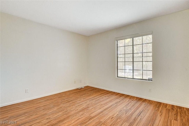 empty room featuring plenty of natural light and light wood-type flooring