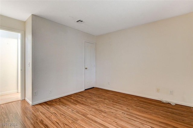 spare room with light hardwood / wood-style flooring